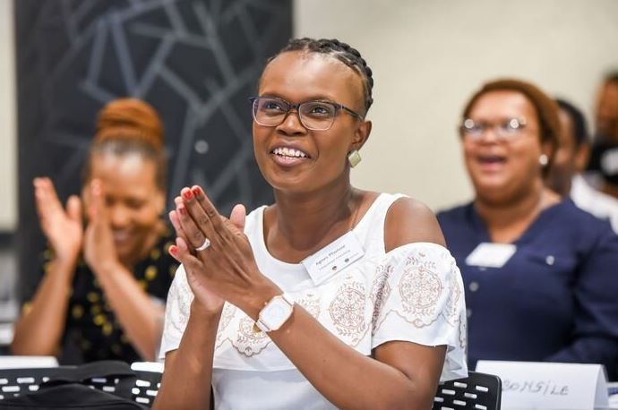 Women clapping in a mentoring conference centre