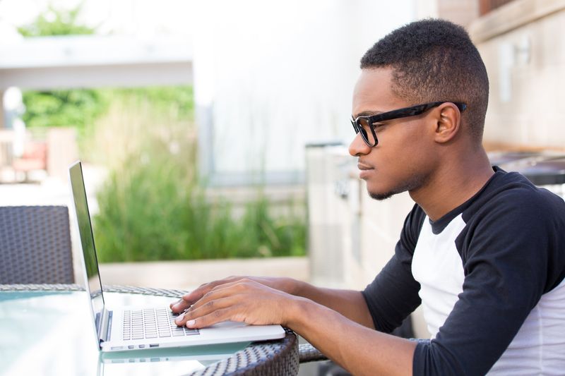 Young black entrepreneur working on laptop.