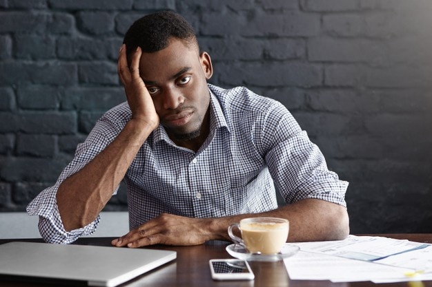 A tired black man at work
