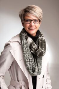 A woman wearing a scarf and coat